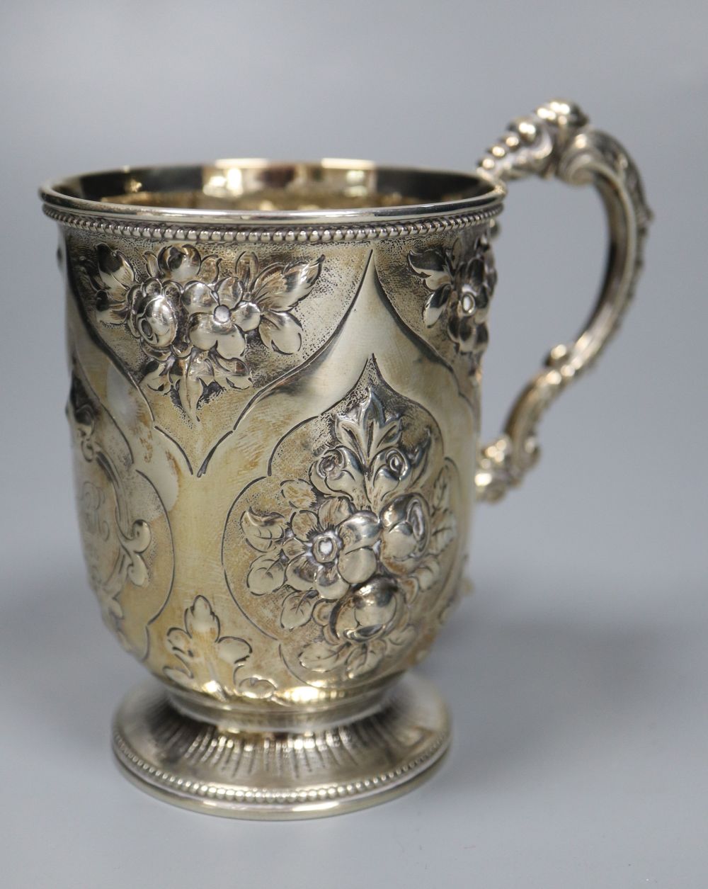 A Victorian embossed silver christening mug, George Adams, London, 1875, 10.7cm, 142 grams.